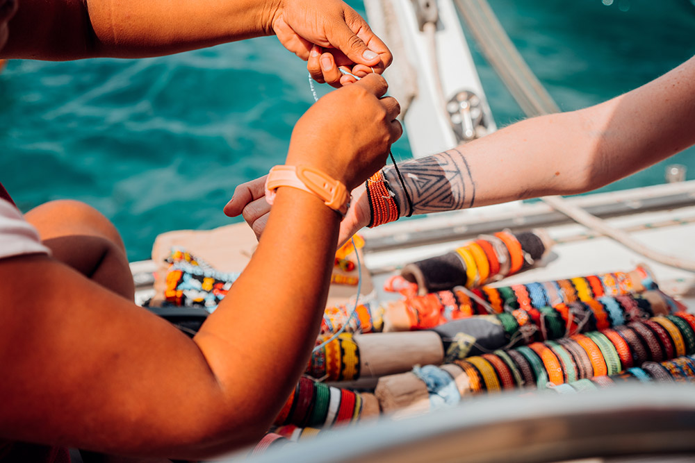 An artisan's hands weaving a traditional textile